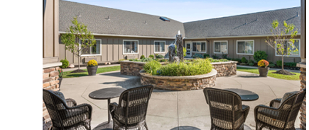 A patio with a table and chairs, a statue, and a fountain. AI generated content